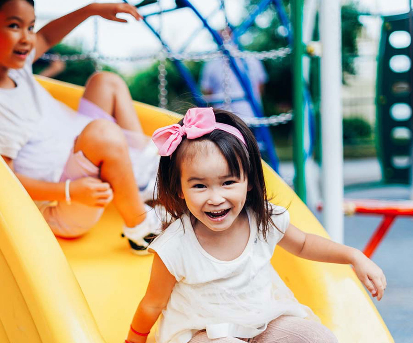 Young girl playing on a slide